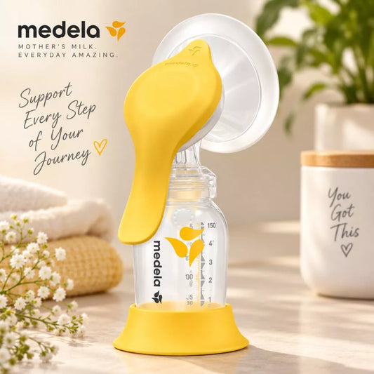 Medela Harmony manual breast pump with yellow ergonomic handle and bottle