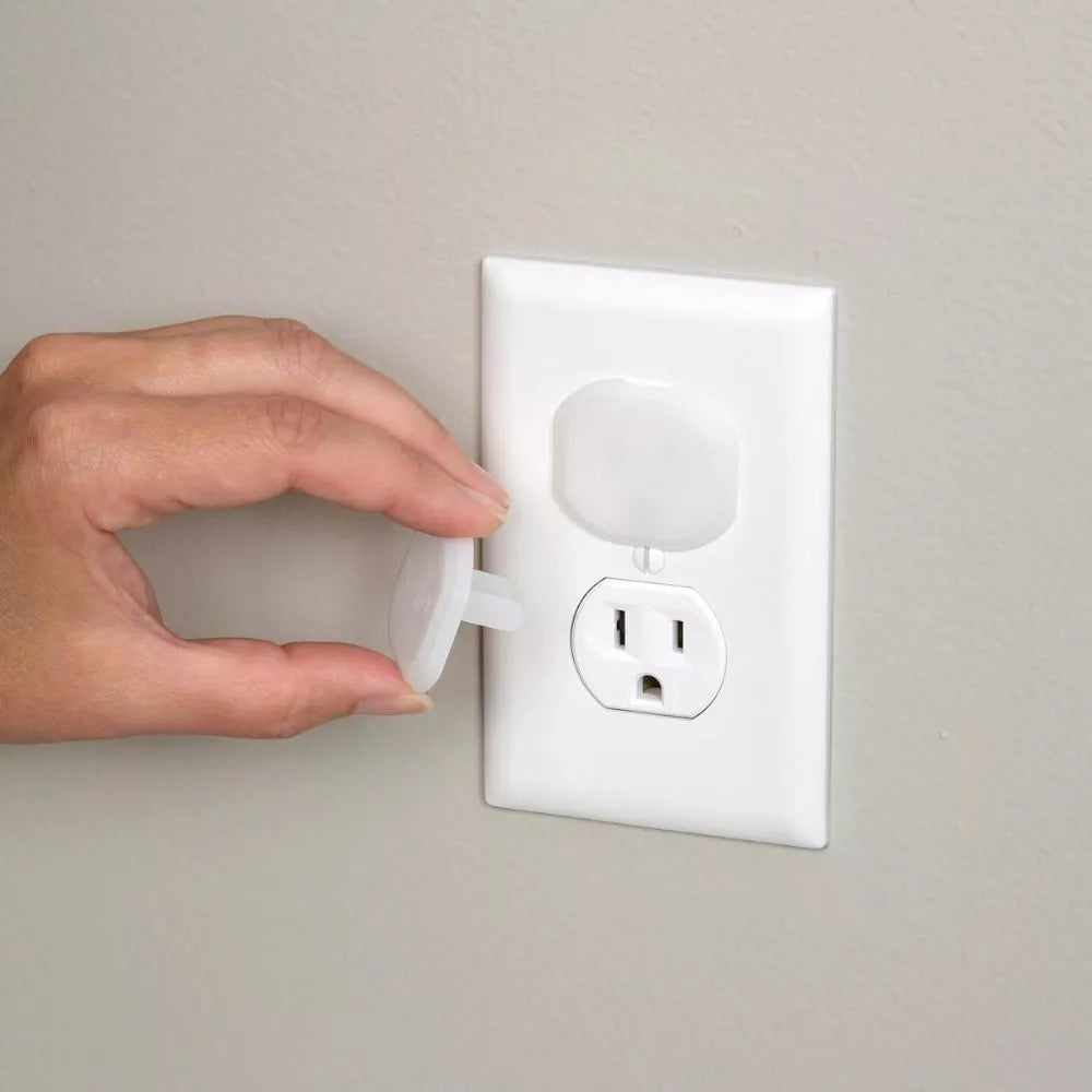 Safety 1st Plug Protector being removed from an electrical outlet